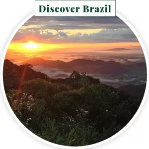 image of a sunrise over mountains below the Discover Brazil button